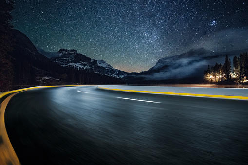road driving under milky way in Yoho national park, Mount Burgess on background,British Columbia, Canada.