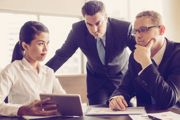 istock Business Team Reviewing Statistics with Tablet 1053783056