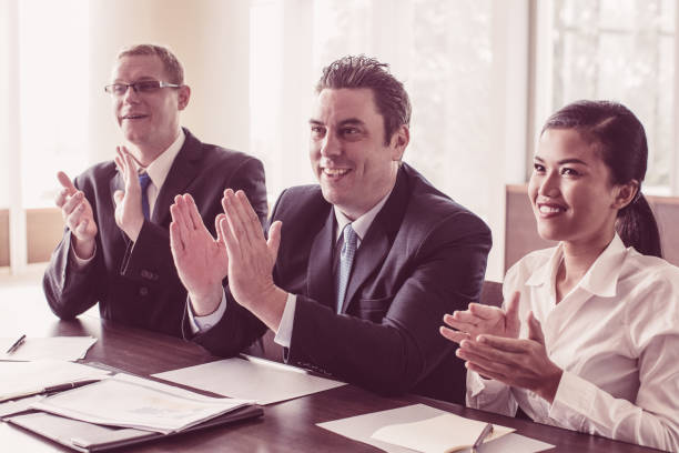 istock Three Meeting Participants Applauding Speaker 1053783114