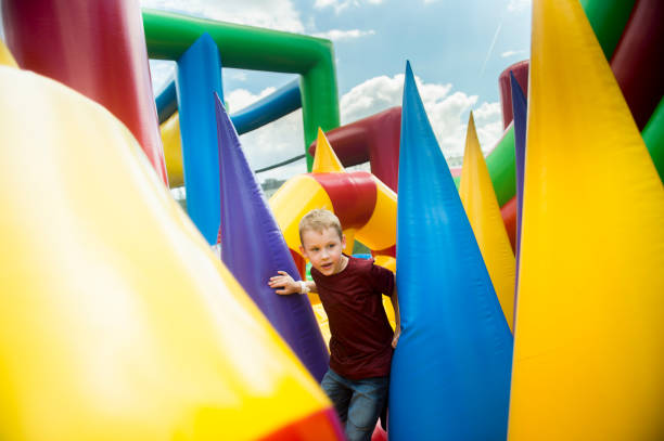 istock Boy Playing On Colorful Bouncy Castle 1053787976