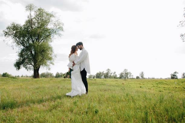 istock Romantic Couple On Field Against Sky 1053791498