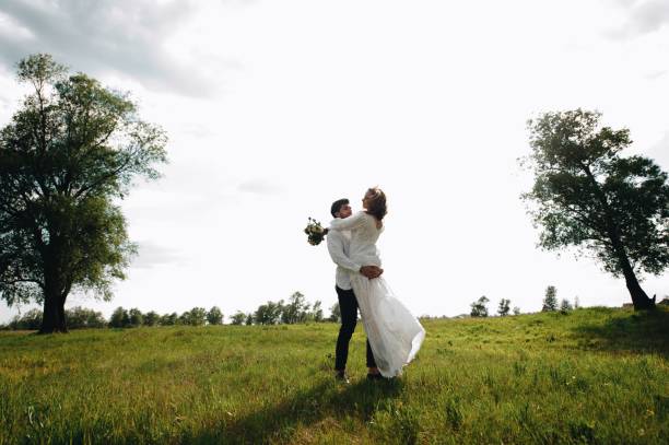 istock Romantic Couple On Field Against Sky 1053791504