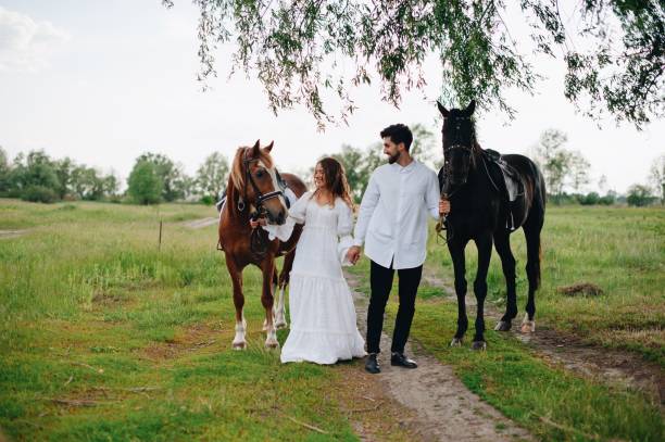 istock Couple With Horses On Field 1053791556