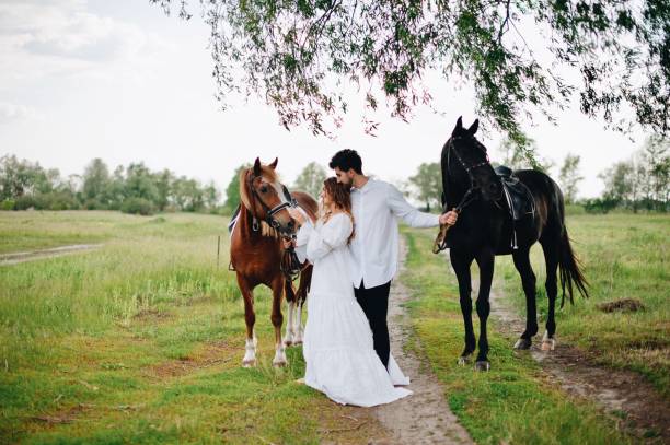 istock Couple With Horse On Field 1053791686