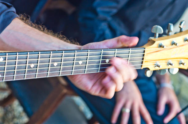 istock hands of musician run fast on the guitar strings 1053795474