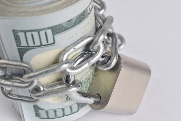 istock Lock With Chain On Paper Currencies Against White Background 1053795718