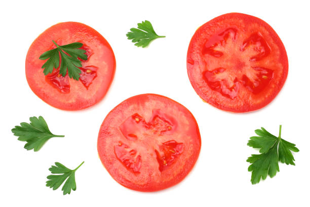 istock slice of tomato with parsley isolated on white background. top view 1053795982