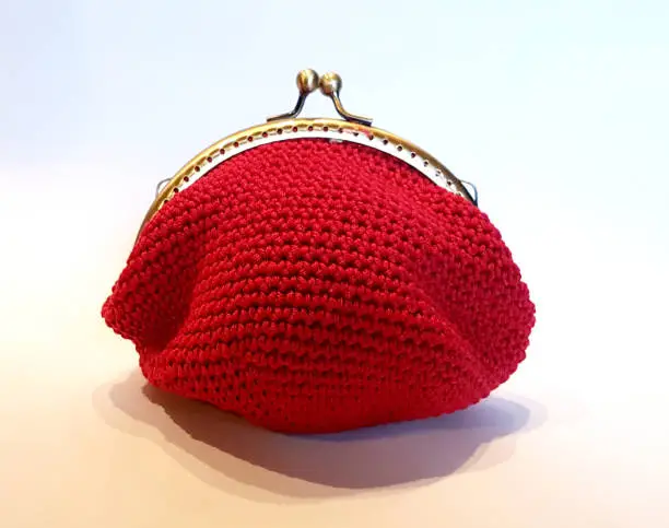 Handmade crochet bag with red cotton thread ready to receive your money and your savings