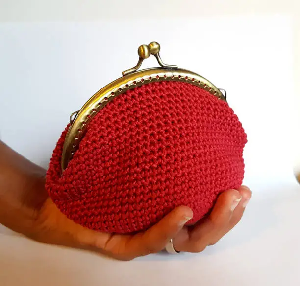 Handmade crochet bag with red cotton thread ready to receive your money and your savings
