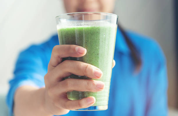 istock Midsection Of Woman Holding Smoothie 1053802792