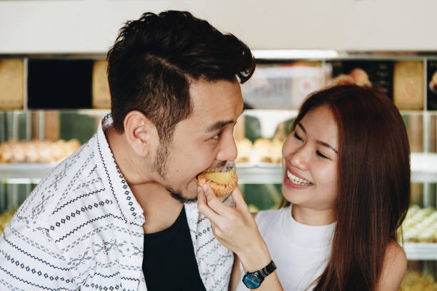 istock Asian girl feeding her boyfriend 1053810826