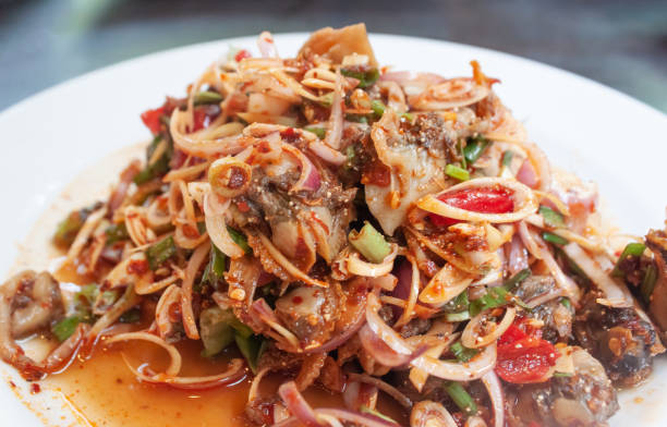 istock Spicy cockle salad in white plate, Thai seafood 1053816922