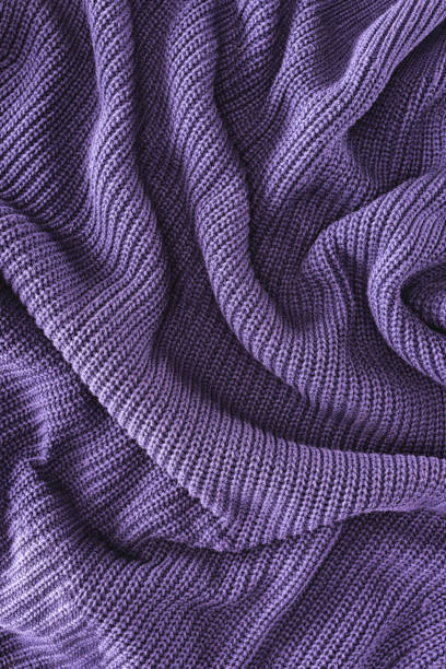 istock full frame of purple folded woolen fabric as background 1053816934