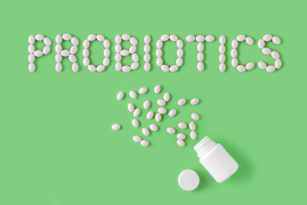 Probiotics word made of pills on green background. Flat lay, top view, free copy space. Probiotics word made of pills on green background. Flat lay, top view, free copy space. probiotic photos stock pictures, royalty-free photos & images