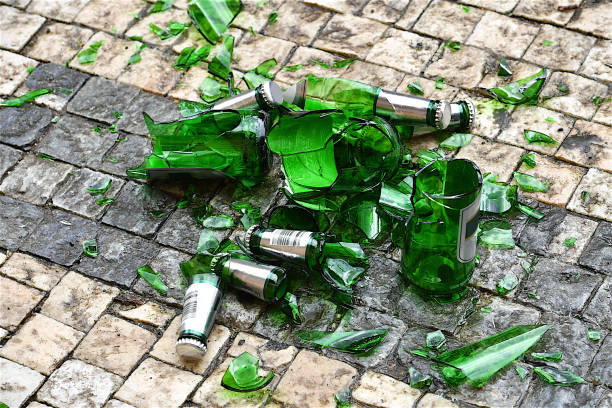 Low Section Of BareFoot Woman Standing on Floor by Broken Glass