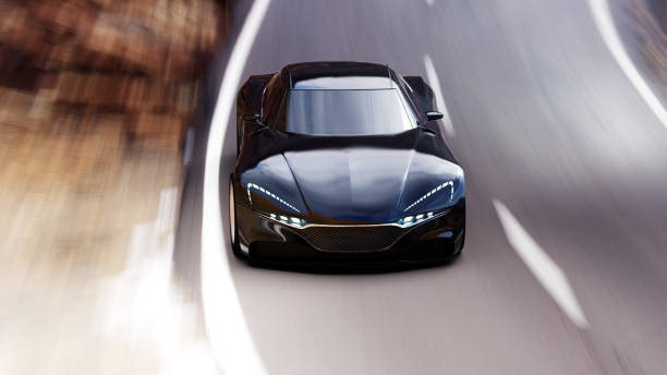 istock black car driving on a mountain road 1053817260