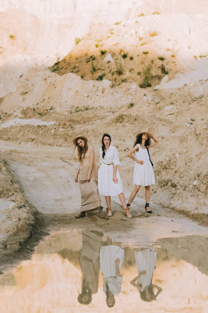 istock attractive girlfriends posing near big puddle with reflection in sandy canyon 1053818796
