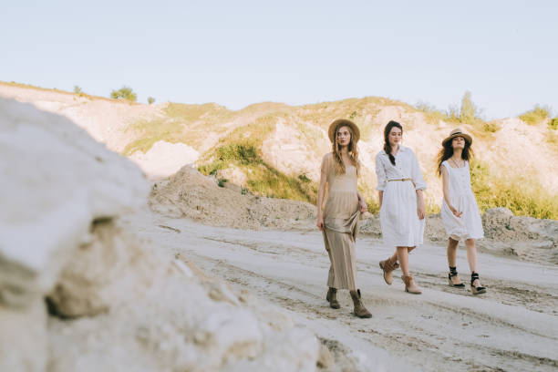 istock attractive stylish girlfriends in straw hats walking in sandy canyon 1053820510