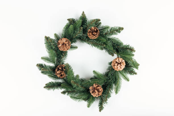 istock top view of beautiful christmas wreath with pine cones on white background 1053821122