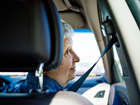 Senior woman traveling by car