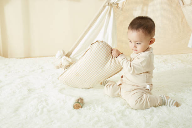 istock The little boy played on the white carpet 1053823534