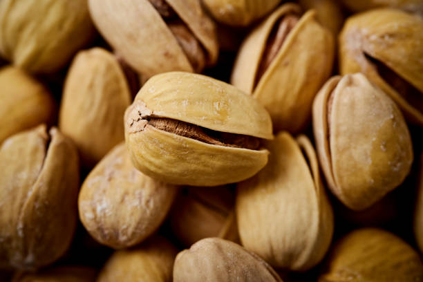 istock background full of delicious pistachios on an table in a pub 1053825612