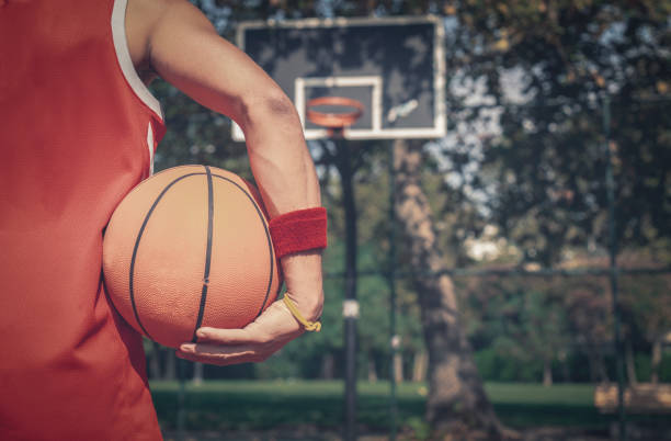 istock Rear view of player with basketball on street 1053828310