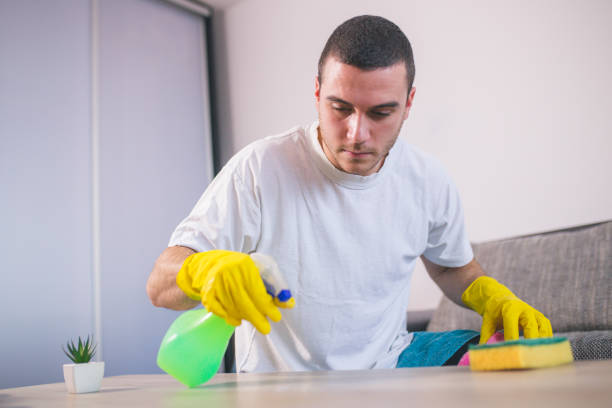 istock Man cleaning the house helping his wife 1053828800