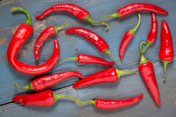 istock Red hot chilli peppers on a gray board table. Top view 1053829118