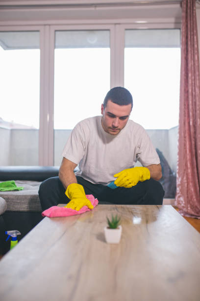 istock Man cleaning the house helping his wife 1053829556