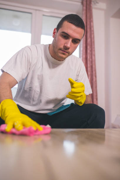 istock Man cleaning the house helping his wife 1053830992