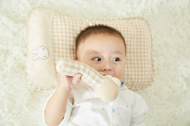 istock The little boy was lying in bed playing 1053831850