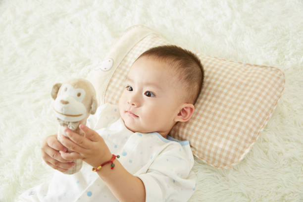 istock The little boy was lying in bed playing 1053831890