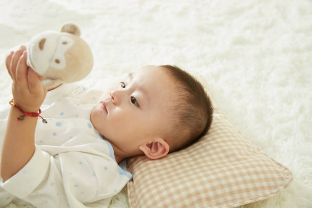 istock The little boy was lying in bed playing 1053831982