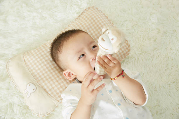 istock The little boy was lying in bed playing 1053832146
