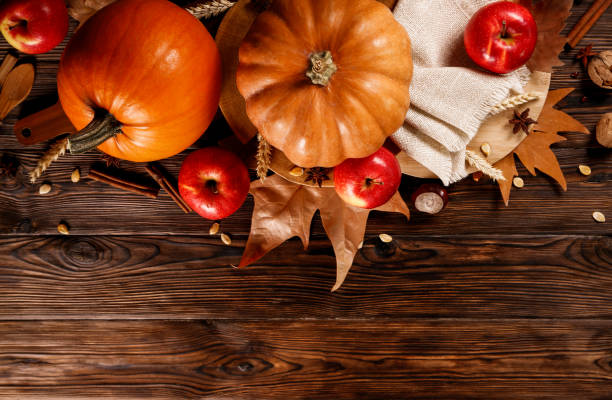 istock Autumnal composition with pumpkins on wooden table. November mood concept. 1053833482