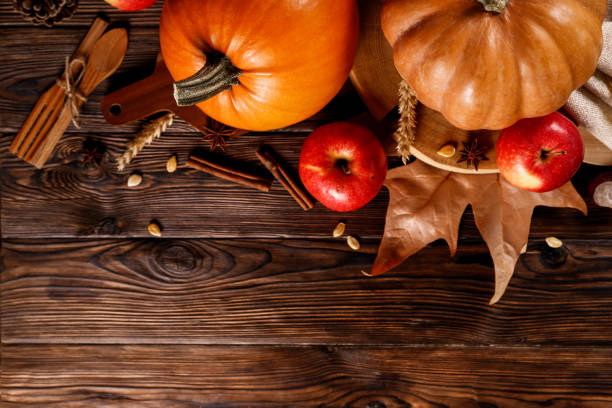 istock Autumnal composition with pumpkins on wooden table. November mood concept. 1053833492