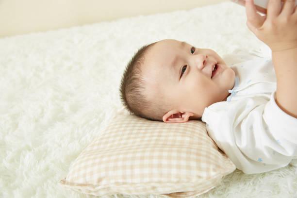 istock The little boy was lying in bed playing 1053833770