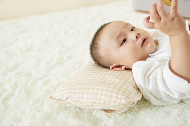 istock The little boy was lying in bed playing 1053833782
