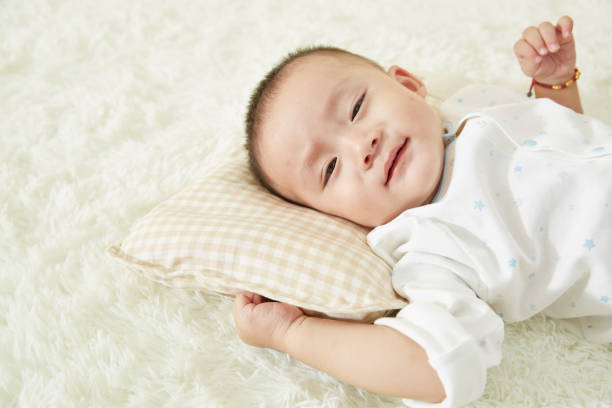 istock The little boy was lying in bed playing 1053834420