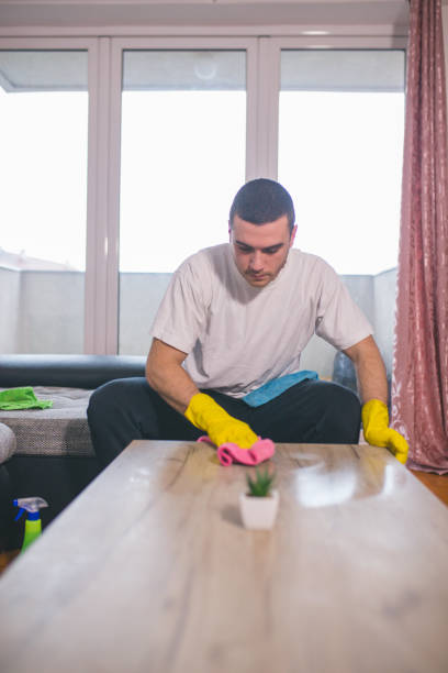 istock Man cleaning the house helping his wife 1053838342