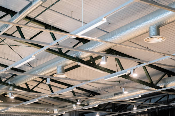 istock Factory building or warehouse building. Vast empty space with ventilation pipes and lights 1053840266