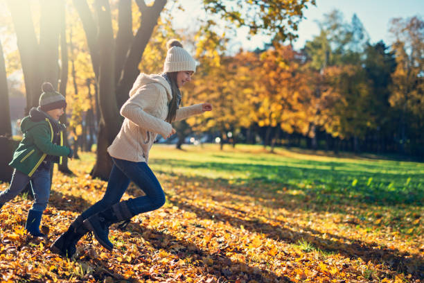 istock Kids running in park on autumn day 1053842920