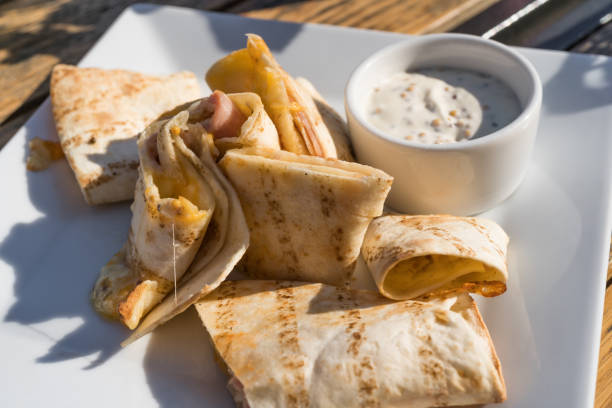 Tortilla rolls with ham and cheese.