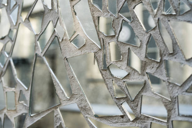 shards of a mirror glass pattern on a wall. - mirror broken mosaic mirrored pattern imagens e fotografias de stock