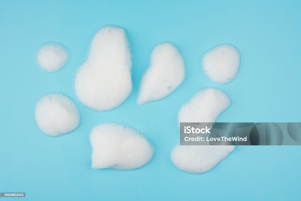 Group of foam bubble on blue background on top view object beatuy health care concept design Soap Sud Stock Photo