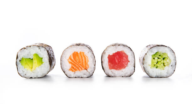 Maki sushi food Four maki rolls in a row with salmon, avocado, tuna and cucumber isolated on white background. Fresh hosomaki pieces with rice and nori. Closeup of delicious japanese food with sushi roll. sushi plate stock pictures, royalty-free photos & images