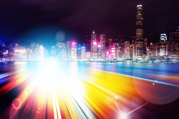 istock Abstract Light trails background with Hong Kong City scraper. double exposure 1053854214