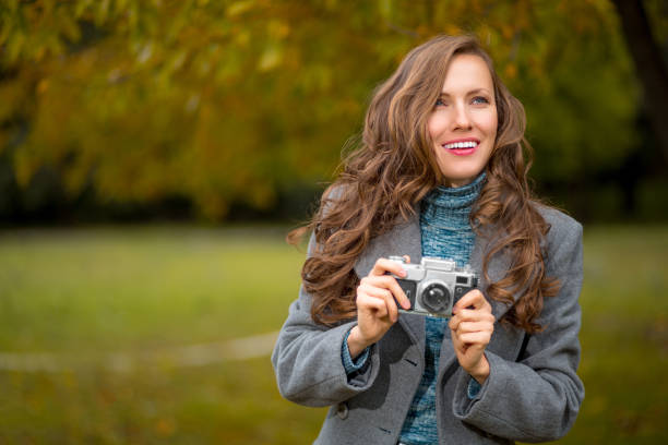 istock Young woman talking pictures outdoors 1053855352