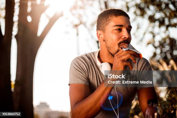 Young Man Eating Candy Bar Stock Photo - Download Image Now - Eating, Protein Bar, Chocolate Bar